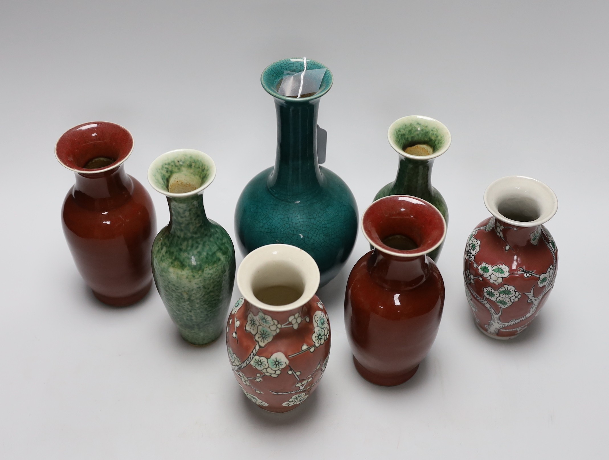 A pair of Chinese sang de boeuf vases, another pair of Chinese mottled green bottles vases, two pink ground prunus vases and a turquoise glaze bottle vase, tallest 23cm (7)